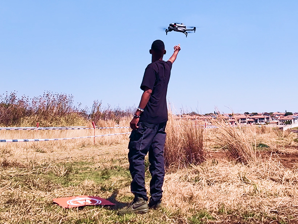Berenith operator launching a drone from a landing pad in an open field