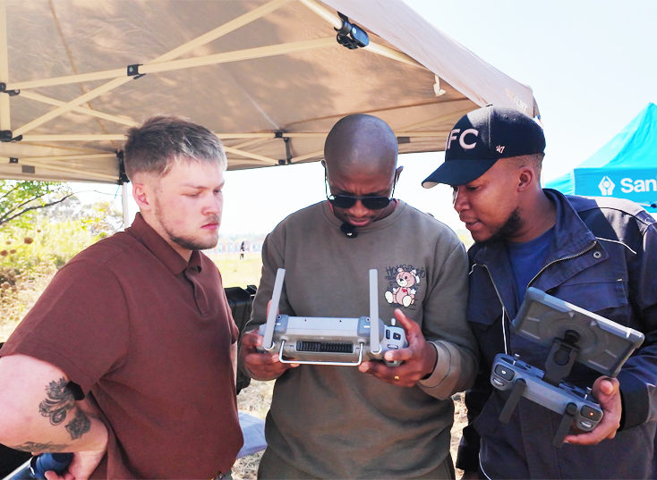 Berenith team reviewing drone controllers together in the field